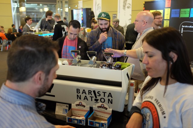 Baristas of Oak Cliff Coffee Roasters serve guests at the Barista Nation Satellite Cafe at the SCAA Event in Boston.