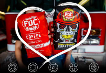 Two Fire Department Coffee bags being held out toward the camera. One bag is Medium Roast Coffee and the other is Shellback Espresso Coffee. The coffee bags are wrapped with a superimposed image of a heart and below are icons for Firefighter, Paramedics/EMS, Police, Nurses and Military members. The background is the setting of a fire station and showing the front end of a red firetruck.