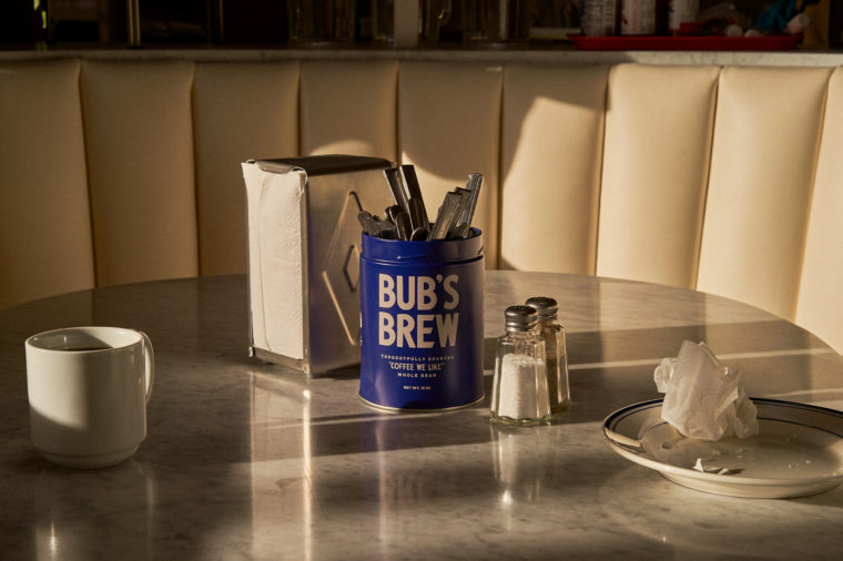 Lifestyle composition of Bub's Brew with cups and napkin dispenser and stark shadows