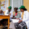 grounds for health volunteers at screening site, February 2025, signing up women for cervical cancer screening.