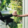 young man receiving coffee at drive thru counter., drive thru and take away for protect covid19.